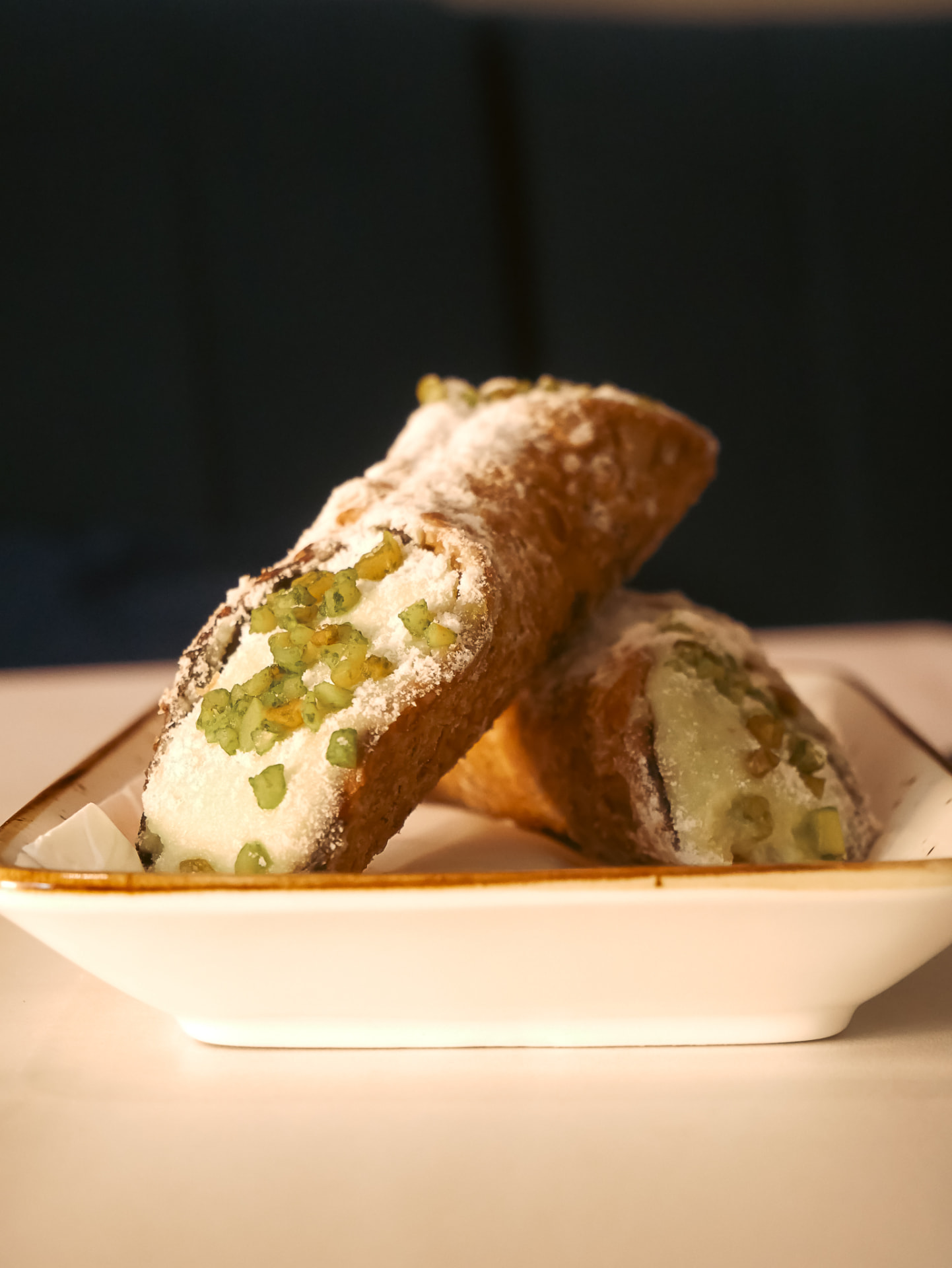 Pistachio cannoli plated at Amico Mio
